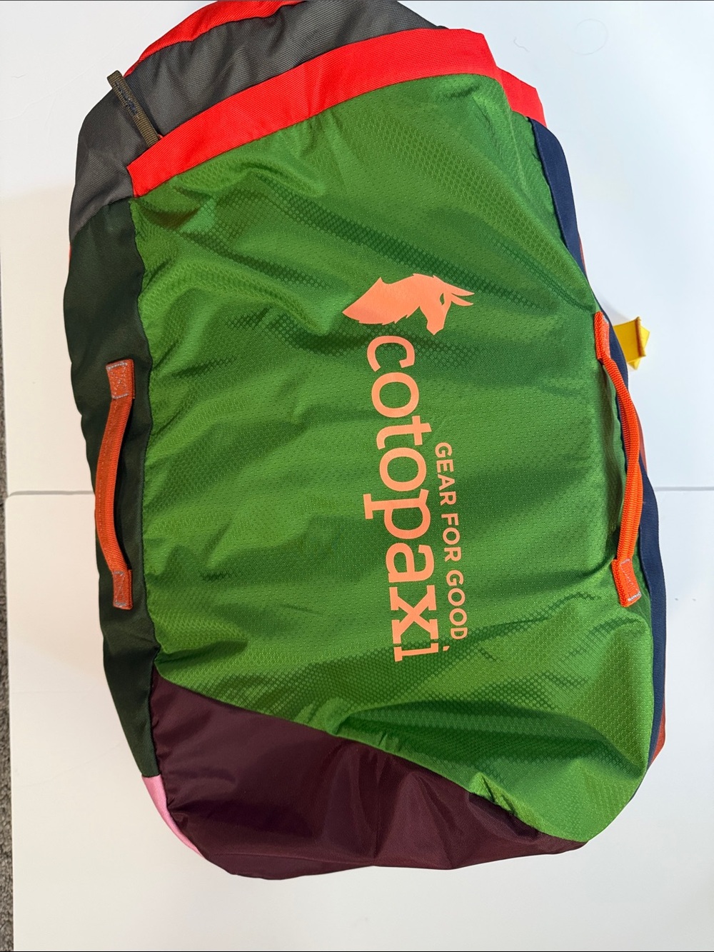 cotopaxi Green Duffel with Orange Logo and Multicolor Panels